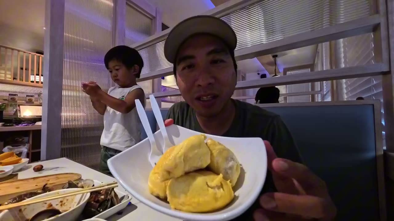 A bowl of durian at Chongqing Wharf with Spencer standing behind Michael