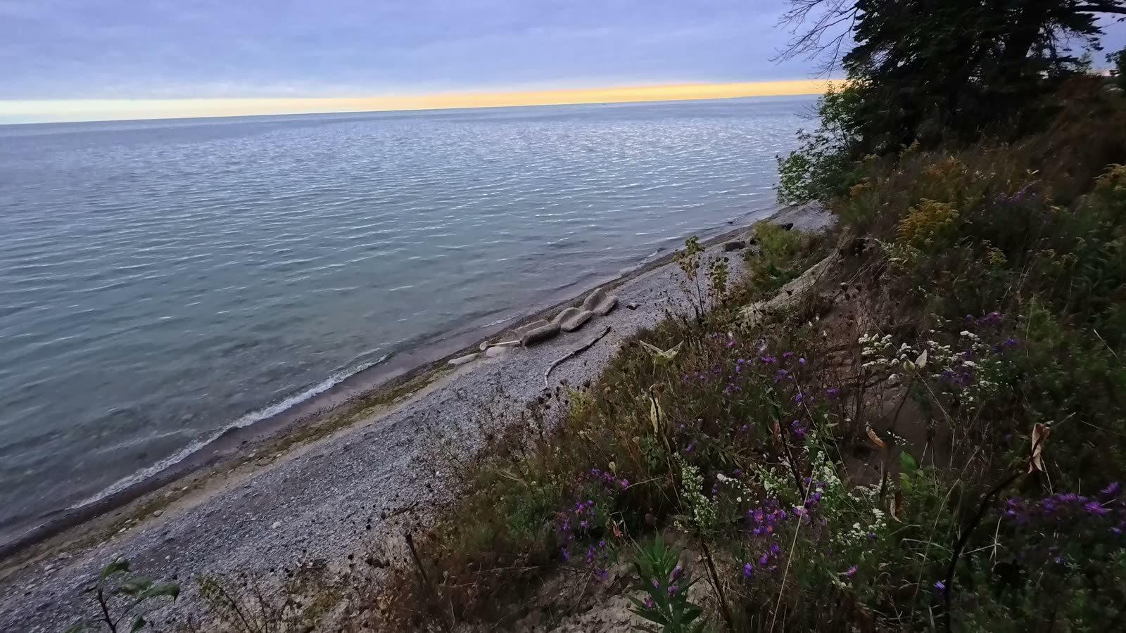 Lake Ontario and a narrow pebble beach seen from the top of the cliff near our campsite at Darlington Provincial Park