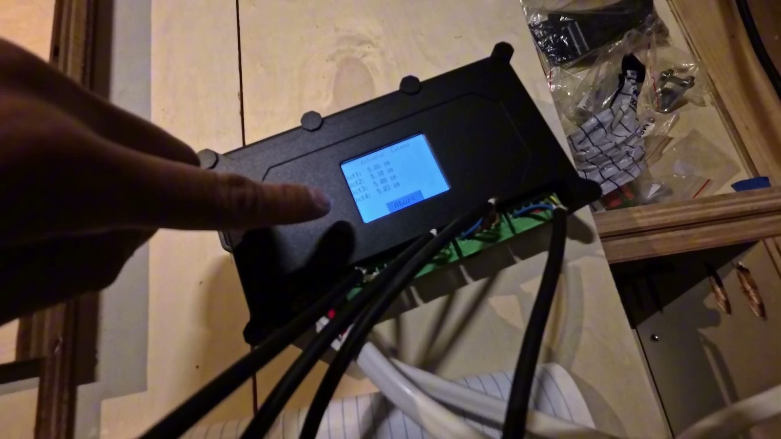 The actuator controller’s LCD screen showing all four actuators at nearly the same length during the first sync test