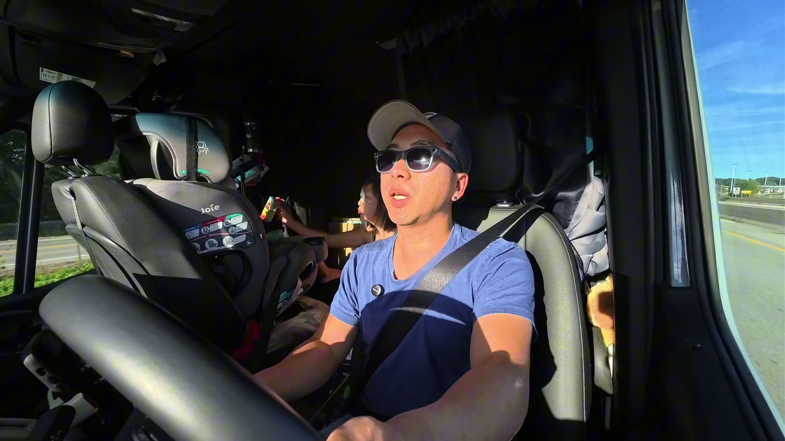 Michael driving the van after crossing into Ontario, with Spencer awake in his car seat behind him