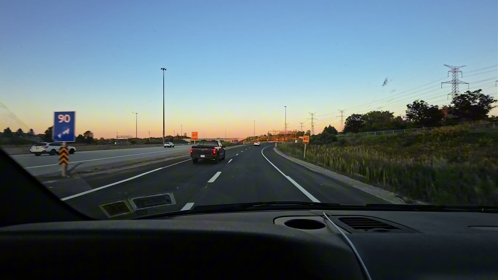 The highway into the Toronto area at sunset, seen through the van windshield