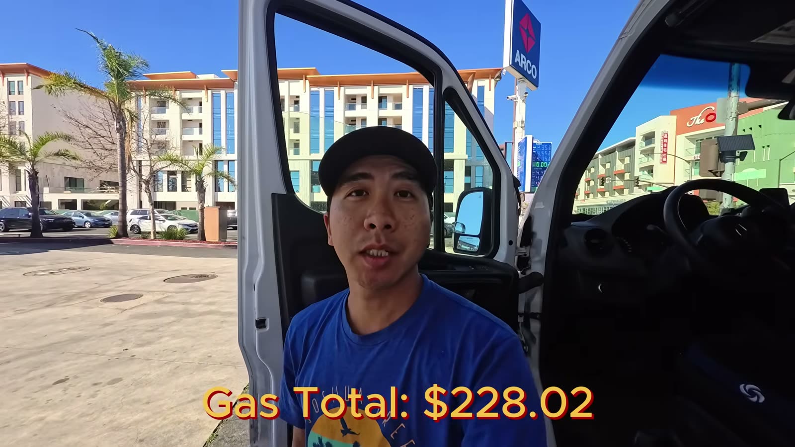 Michael standing at the open van door at a gas station with an on-screen gas total of $228.02