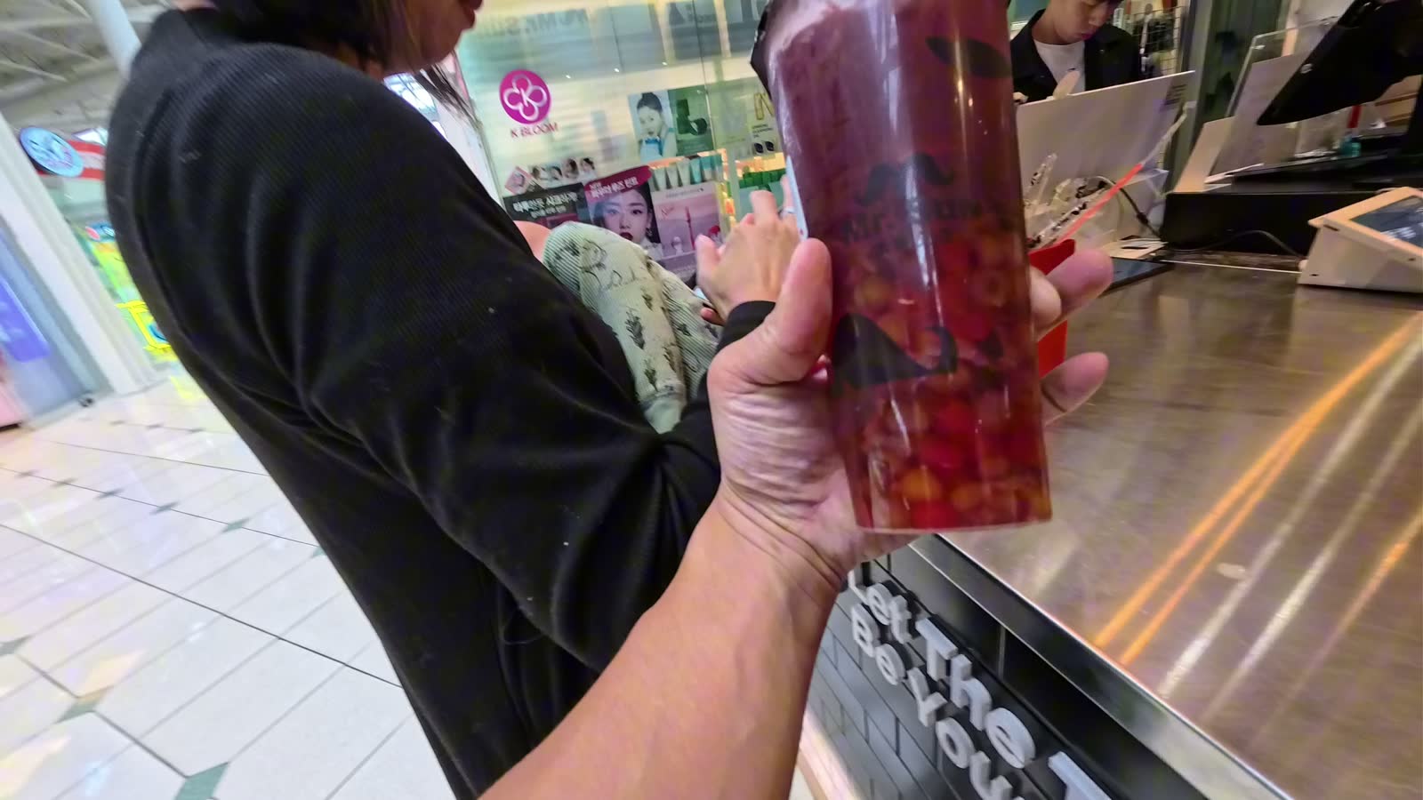 Rina holding a large grape green tea from Mr. Sun International Tea Shop inside Pacific Mall