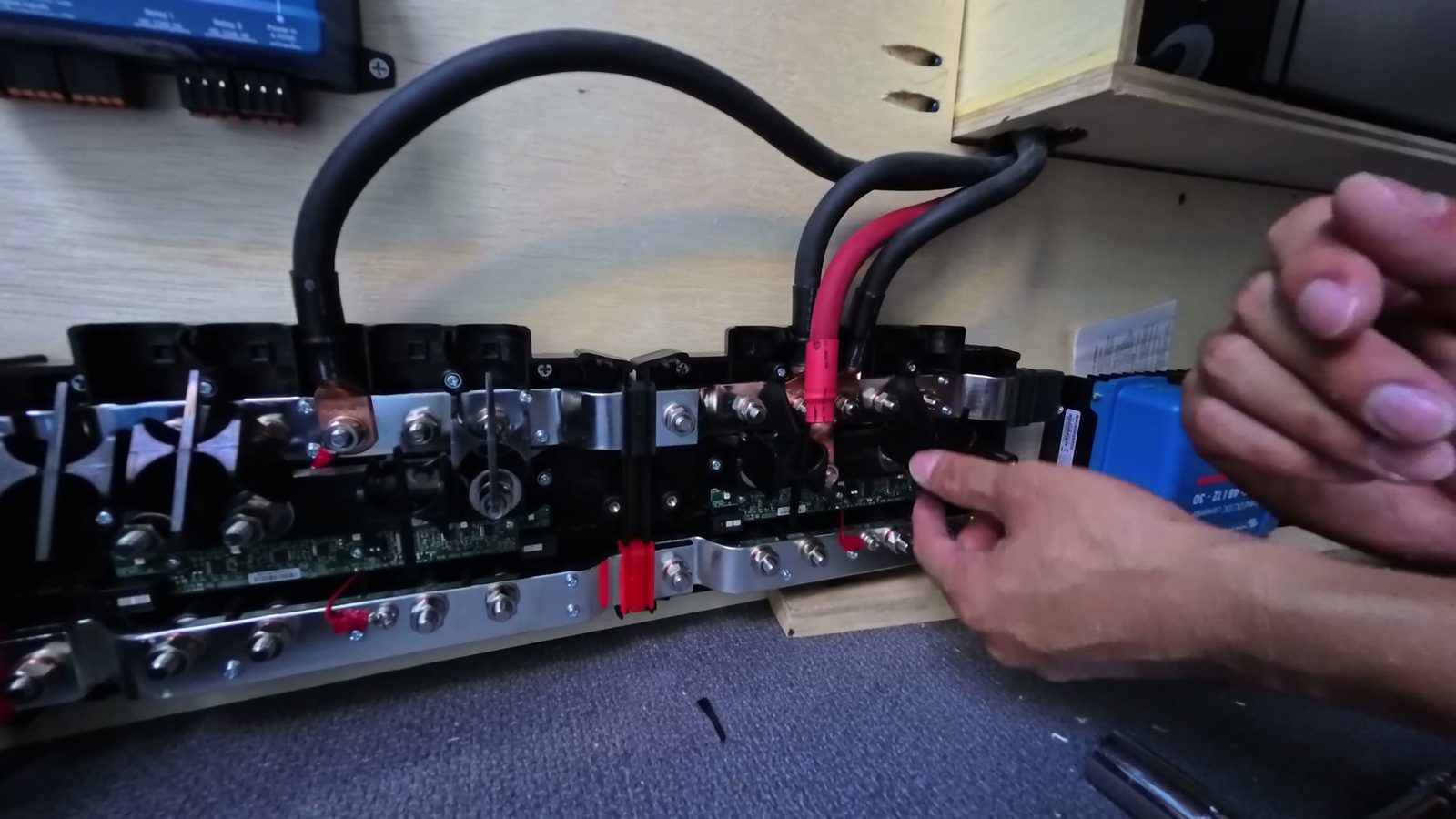 The assembled Victron Lynx panel with the shunt and distributors, and heavy 2/0 cables being connected