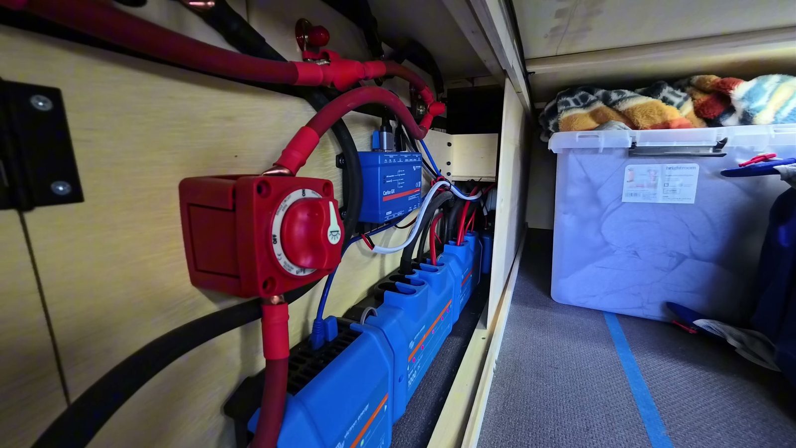 Red Blue Sea battery isolator switch and Victron Cerbo GX mounted above the Lynx distributors