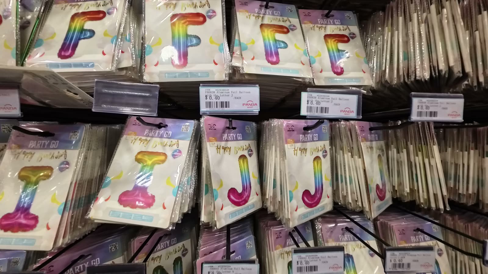 Rows of letter foil balloons at Panda Mart with $0.40 price tags
