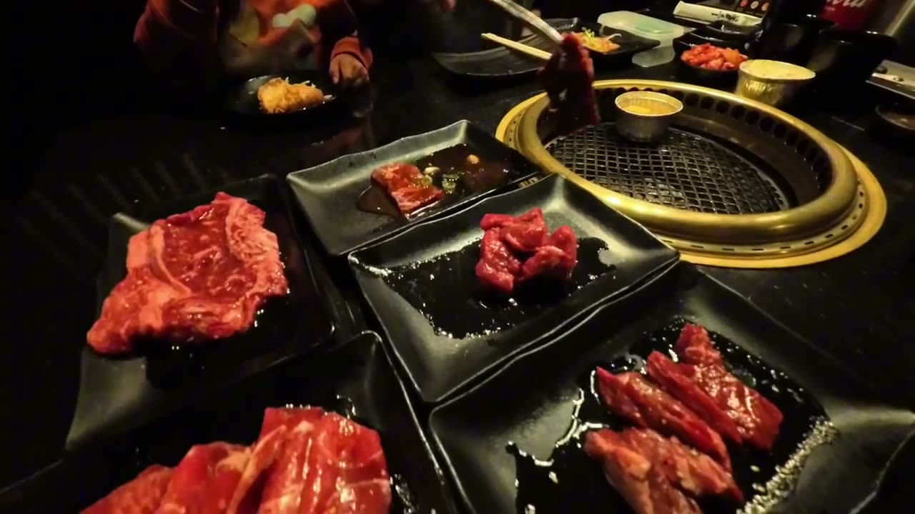 Plates of marbled raw beef next to the tabletop grill at 888 Japanese BBQ in Las Vegas