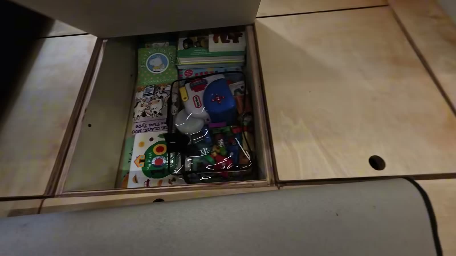 Spencer’s toys stored in a hatch under the floor of the van
