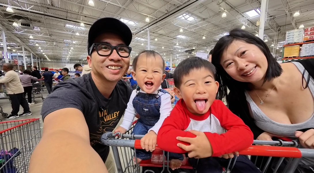 The four of us at Costco with the boys in the cart