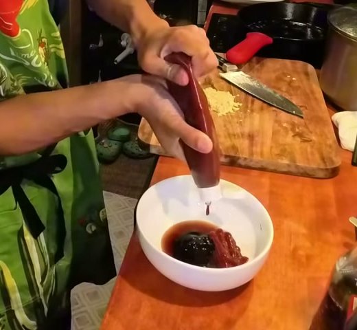 Ketchup going into a bowl with hoisin sauce and chicken bouillon to make the garlic sauce