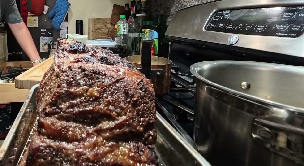 A prime rib with a dark, crackly crust on a rack after the 500 degree oven