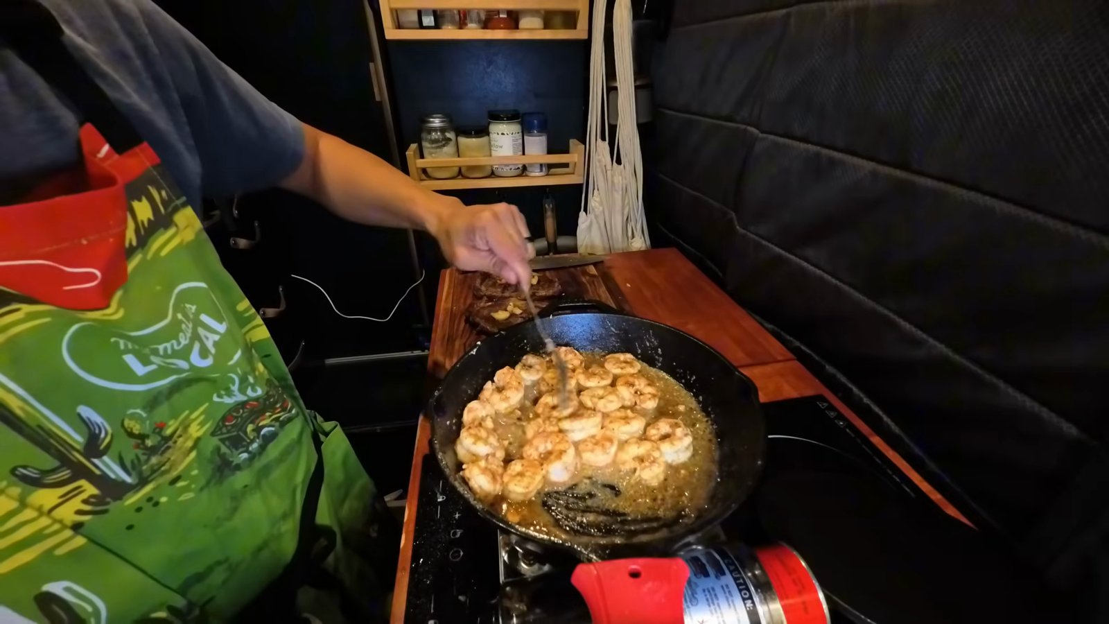 Shrimp cooking in garlic butter in a cast iron pan