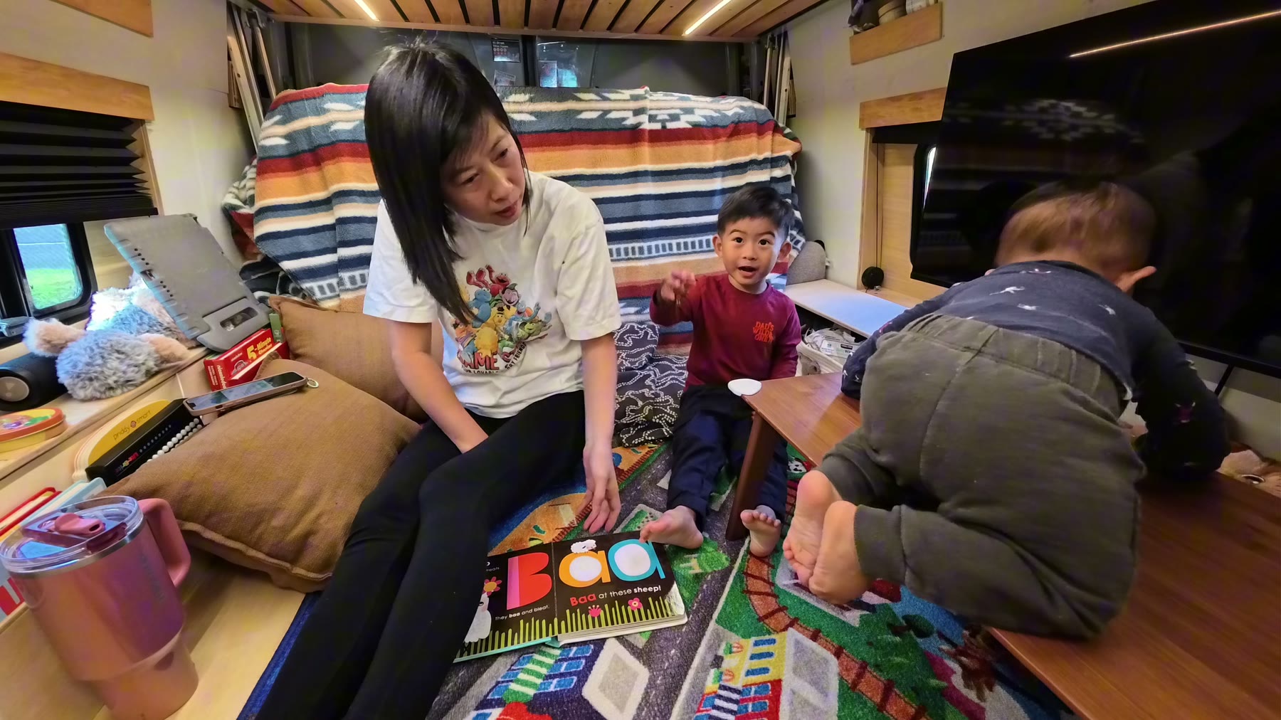 Rina with Spencer and Archie inside the van