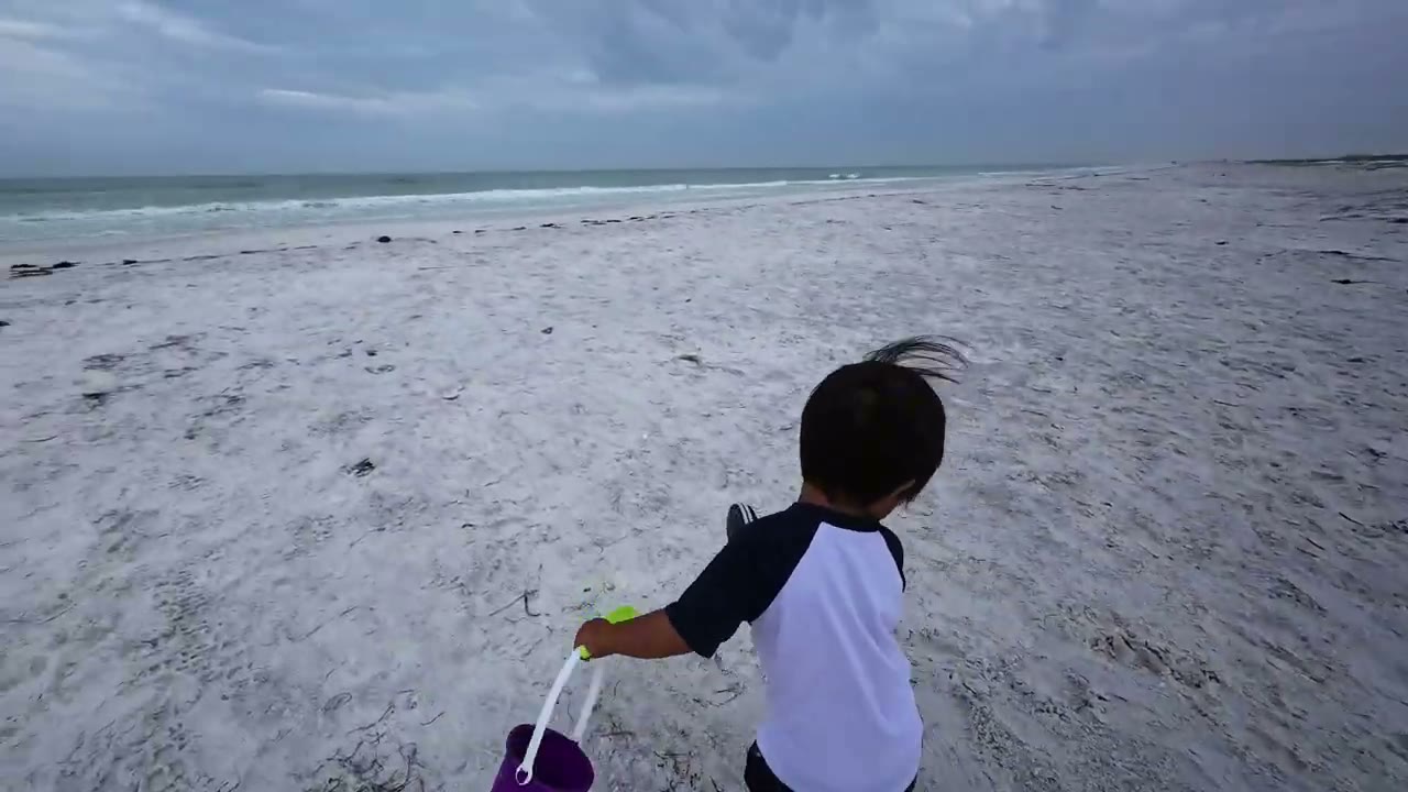 Spencer running on a beach