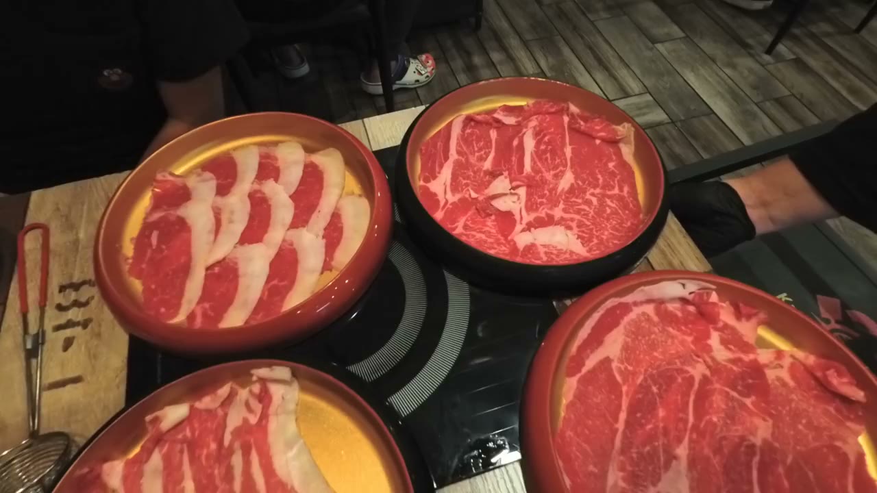 Plates of sliced wagyu at an all-you-can-eat hotpot